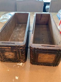 two wooden boxes sitting on top of a table