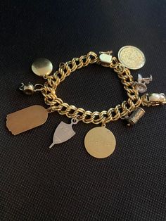 "Wonderful Elco gold filled charms bracelet , include 9 charms happy birthday, graduation,two signed Jostens and one 1/20 12k gold filled J.M.F co  round small locker, two tea pot, one car, two wine glass the bracelet is double curb links ,you can add another charm of your preference. In excellent condition. Mes 7 1/4\" Long Please contact me with any questions and don't forget to check my other items in my shop  Thank you for shopping at Maggiememorybox." Vintage 14k Gold Bracelet For Anniversary, Vintage Personalized Jewelry For Collectors, Vintage Gold Charm Bracelet Gift, Vintage Gold Bracelets With Charms, Yellow Gold Charm Bracelet With Vintage Charm As Gift, Antique Gold Charms For Collectors, Gold Vintage Bracelets With Charms, Vintage Engraved Yellow Gold Charm Bracelet, Vintage Hallmarked Gold Bracelet For Anniversary