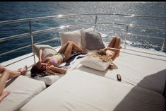 two women lounging on the back of a boat