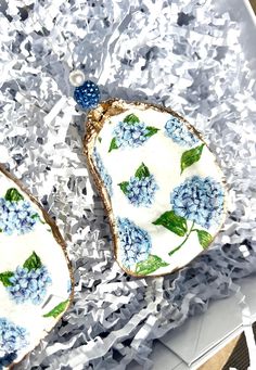 two pieces of bread with blue and white flowers on them sitting in tinfoil paper