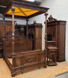 an antique wooden bed with canopy and matching dressers