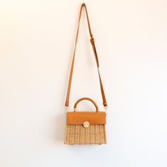 NOW AVAILABLE IN STOCK. FAST SHIPPING FROM LOS ANGELES. 3-5 DAYS This exquisite Elena Handbags Straw Woven Box Bag featuring a leather flap and trims is a sophisticated addition to any wardrobe. Crafted from natural straw material, its classic style is further enhanced with leather accents for a timelessly elegant look. Perfect for formal occasions or everyday wear. Material: Straw + PU Leather Size: 21cm wide x 24cm tall (8in x 9in) Designer Style ID: 8283 Square Straw Bag With Detachable Strap For Travel, Brown Square Straw Bag With Detachable Handle, Travel Rectangular Straw Bag With Detachable Strap, Rectangular Brown Straw Bag With Detachable Handle, Brown Rectangular Straw Bag With Detachable Handle, Rectangular Natural Straw Bag With Detachable Strap, Beige Square Straw Bag With Detachable Strap, Natural Rectangular Straw Bag With Detachable Strap, Rectangular Straw Bag With Detachable Strap For Shopping