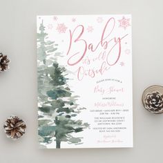 a baby is coming card with pine cones on the side and snowflakes around it