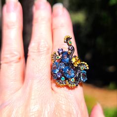 This Is A Stunning New Sparkling Blue Topaz And Amethyst Peacock Ring. This Is Such A Beautiful And Unique Piece. This Stunner Is Made With 925 Sterling Silver Covered In Rhodium With 24k Gold Accents And Findings. It Has Amethyst And Smaller Topaz Accent Stones For The Eyes. The Size Is 8.5 Ring. Please Ask Questions And Make An Offer. I Can't Say Yes If You Don't Ask! Blue Jeweled Rings For Gifts, Blue Jeweled Rings For Gift, Wedding Rings With Peacock Design, Unique Sapphire Jewelry, Elegant Blue Peacock Design Jewelry, Unique Blue Multi-stone Topaz Ring, Peacock Ring, Gold Accents, Blue Gold