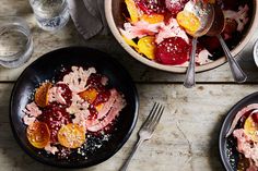 a bowl filled with fruit and topped with powdered sugar next to another bowl full of food