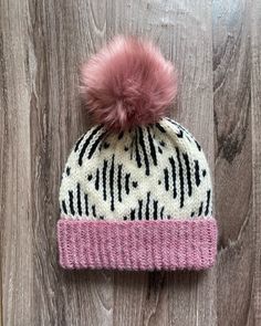 This warm double-brimmed hat is fitted and sits snugly on your head. Perfect for keeping you warm in the winter. The hat was made by me from 80% acrylic, 20% wool yarn in a pet-free and smoke-free home. This hat also features a pink faux fur pom pom. Care: Hand wash and lay flat to dry. These items are handmade and, as such, minor imperfections are to be expected. Fitted Acrylic Hats For Winter, Fitted Acrylic Winter Hat, Outdoor Acrylic Hat, Hand-knitted Fitted Hats For Cold Weather, Hand Knitted Fitted Hats For Cold Weather, Fitted Hand Knitted Hats For Cold Weather, Fitted Knitted Hat For Cold Weather, Warm Wool Hats For Cold Weather, Outdoor Acrylic Cap