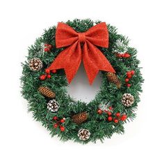 a christmas wreath with pine cones, berries and a red bow on white background photo