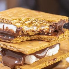 three graham crackers stacked on top of each other with chocolate and marshmallows