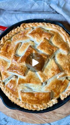 a pie sitting on top of a wooden cutting board