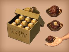 a box filled with chocolate covered donuts on top of a brown table next to two hands