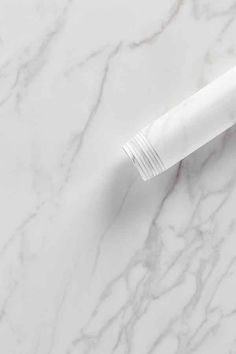 a white toothbrush sitting on top of a marble counter