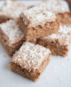 several pieces of cake sitting on top of a white plate covered in powdered sugar