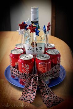 a birthday cake made to look like a bottle of bacardi and six cans of soda