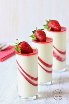 three dessert cups with strawberries in them