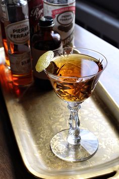 a glass filled with liquid sitting on top of a tray