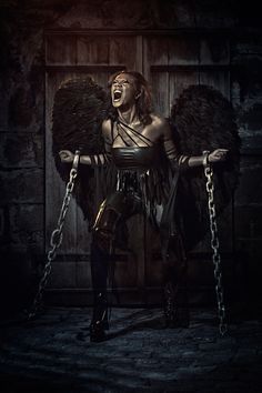 a woman with chains and wings on her chest