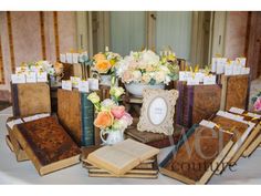 a table topped with lots of books and flowers