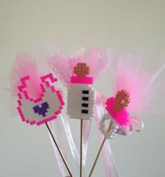 some pink and white cupcake toppers on sticks