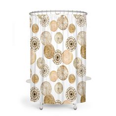 a shower curtain with shells and circles on the bottom, in gold foiled colors