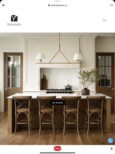 a kitchen island with four stools in front of it