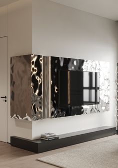 a large mirror mounted to the side of a wall in a living room next to a tv