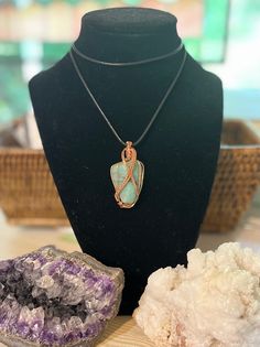 One of a kind tumbled and polished green stone hand wrapped in copper wire. Perfect gift for anyone who appreciates precious stones and one-of-a-kind jewelry. No two pendants are alike! Benefits of Wearing Copper Jewelry: It's known to help reduce inflammation, arthritis, headaches, and improve digestions. It helps bring the body into alignment. It amplifies energy and is an excellent conductor that helps stimulate the flow of energy. If you have any questions, please message me on here. Thank you for your time and have a wonderful day! Turquoise Copper Wire Necklace Gift, Turquoise Copper Wire Necklace As Gift, Turquoise Copper Wire Necklace For Gift, Green Copper Hand Wrapped Necklaces, Green Hand Wrapped Copper Necklace, Amazonite Wire Wrapped Necklaces As Gift, Handmade Green Tumbled Jewelry, Green Wire Wrapped Copper Wire Necklaces, Just Because Gifts