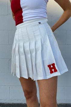 The Tennis Skirt! Our vintage tennis skirt features an invisible zipper and built-in shorts for ultimate comfort. This trendy skirt is a necessity! SIZING AND DETAILS Sizing: XS-XXL Built-in shorts Invisible 85% Polyester, 15% Cotton Embroidered logo application P.S. We’d love to see you repping this style! Make sure to tag us (@hypeandvice) to be featured :) Fitted White Tennis Skirt With Go-dry, Fitted White Tennis Skirt With Go-dry Technology, Game Day Tennis Skirt, White Tennis Skirt With Built-in Shorts For Cheerleading, Harvard Cheer Uniform, Pleated Tennis Skirt, Tennis Team, Vintage Tennis, Tennis Match