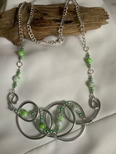 Pretty unique green twisted wire necklace. Designer made. Green Beaded Metal Necklaces, Green Wire Wrapped Adjustable Necklace, Handmade Green Metal Necklaces, Adjustable Green Wire Wrapped Necklace, Elegant Green Wire Wrapped Necklace, Adjustable Green Metal Necklaces, Green Wire Wrapped Beaded Necklaces With Round Beads, Green Wire Wrapped Beaded Necklaces For Gifts, Green Wire Wrapped Beaded Necklaces As Gift