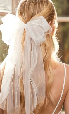 the back of a woman's head wearing a white veil