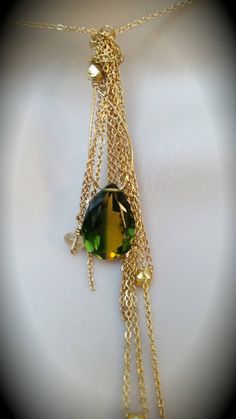 "I designed this necklace for Stassi based on the color and shape of the stone. Stassi loves the green and yellow colors in the quartz teardrop stone (12mm X 14mm). She wanted me to create a necklace based off her \"Boho\" style. This necklace can be made in sterling silver or 14k gold fill flat cable chain. The chains fall like a \"messy\" tassel, all different lengths. There are several citrine stones and 22k gold plated nuggets that are at the bottom of some of the chains. There are several s Green Teardrop Pendant Drop Necklace As Gift, Green Teardrop Pendant Drop Necklace For Gift, Green Teardrop Necklace For May Birthstone, Green Pear-shaped May Birthstone Necklaces, Green Gemstone Drop Necklaces, Green Gemstone Drop Necklace, Green Crystal Pendant Necklace With Adjustable Chain, Green Pendant Crystal Necklace With Adjustable Chain, Green Drop Necklace For May Birthstone