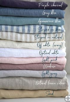 a stack of folded linens with the names of different colors and sizes on them