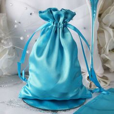 a blue satin bag sitting on top of a table