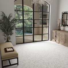 a living room with white carpet and glass doors