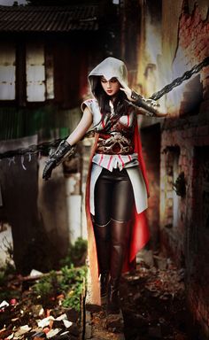 a woman dressed as a pirate holding two swords in her hands and standing on the ground