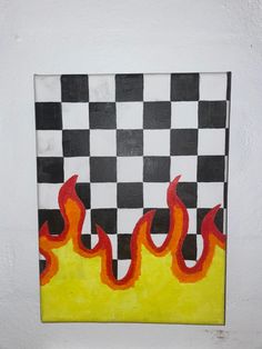 a piece of art with flames painted on the side of it in black, white and yellow