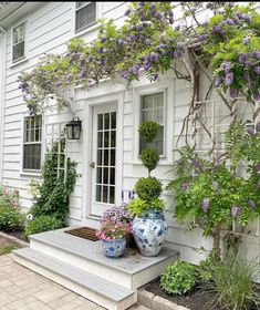 the instagram page shows an image of a house with purple flowers in pots on it