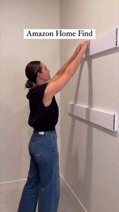 a woman is standing in front of a wall with the words amazon home find on it