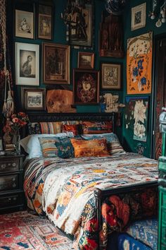 a bedroom with green walls and pictures on the wall above the bed, as well as an antique dresser