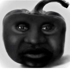 a black and white photo of a pepper with an evil look on it's face