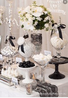 a table topped with lots of different types of candies and desserts on top of it