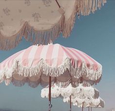 an umbrella with tassels on the beach