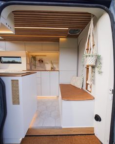 the inside of a small kitchen with an oven and counter top in it's back door