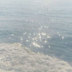 the back end of a boat in the water with sun shining on it's side