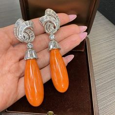 For Sale on 1stDibs - Each suspending a smooth coral drop, from a platinum cap, accented by baguette-cut diamonds these gorgeous David Webb earrings are absolutely stunning.