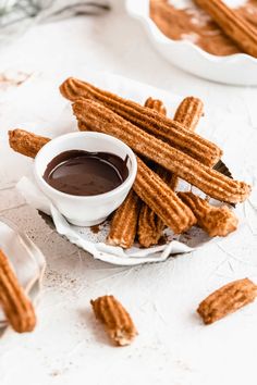 cinnamon coconut sugar churros on a plate with dipping sauce