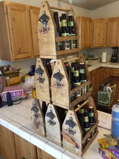 several wooden bird houses are stacked on top of each other in a kitchen with lots of clutter