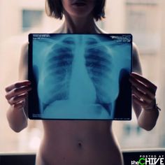 a woman holding up a x - ray image in front of her face and chest