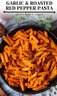 a skillet filled with garlic and roasted red pepper pasta