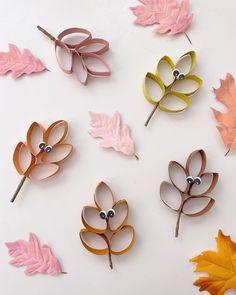 paper leaves are arranged on a white surface