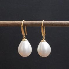 Teardrop shape shell set in vermeil ear wire Pearl Earrings Dangle, Ear Wire, Mother Of Pearl, Sea Shells, Dangle Earrings, Pearl Earrings, Shells